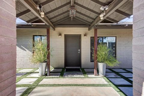 Covered front entry with a wooden door