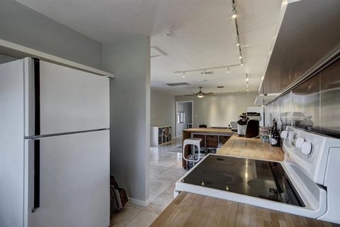 Kitchen with a refrigerator and cooktop